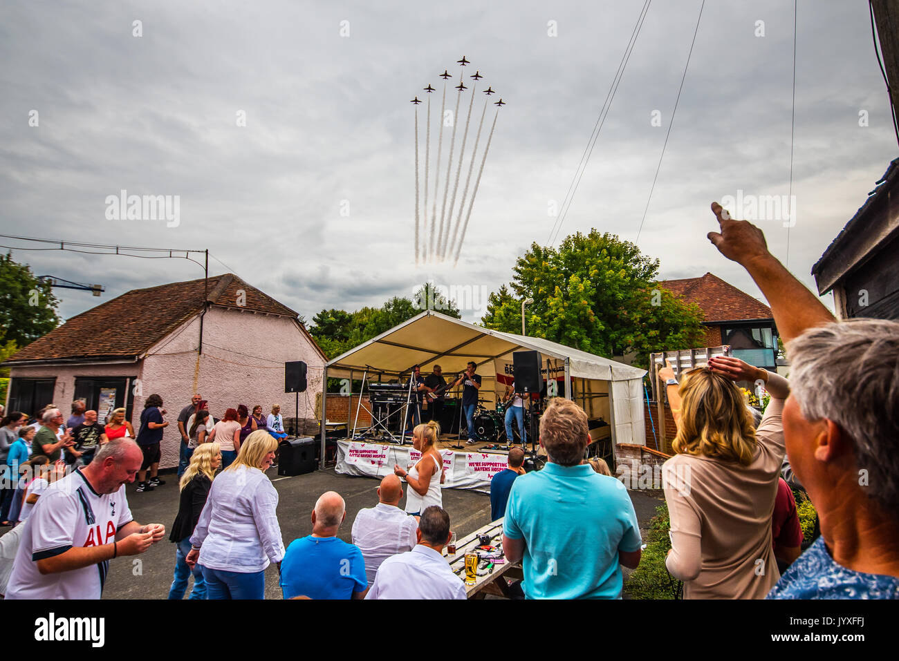 The Bell pub in Ingatestone, near Chelmsford, Essex, enjoyed an additional element as the Royal Air Force's Red Arrows display team flew over the music festival Stock Photo