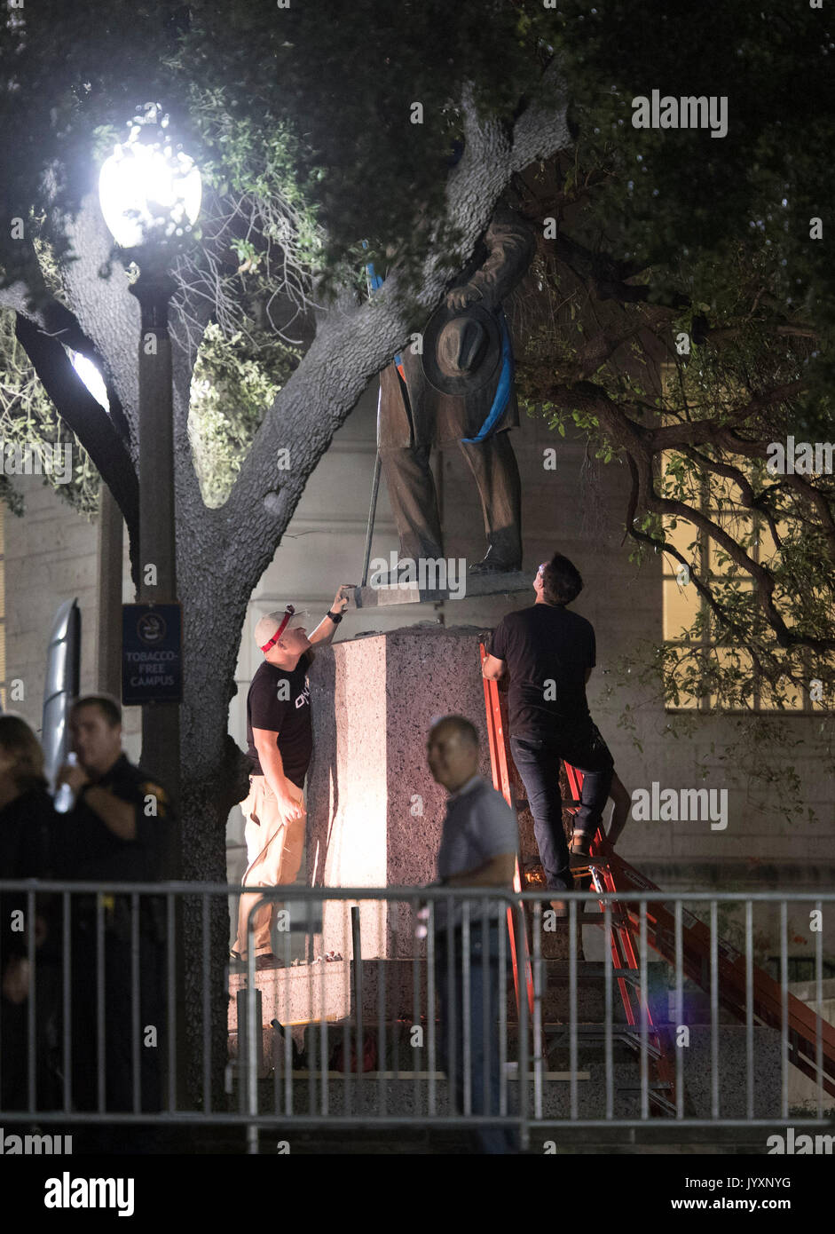 Workers remove the second of four statues of Confederate heroes at the