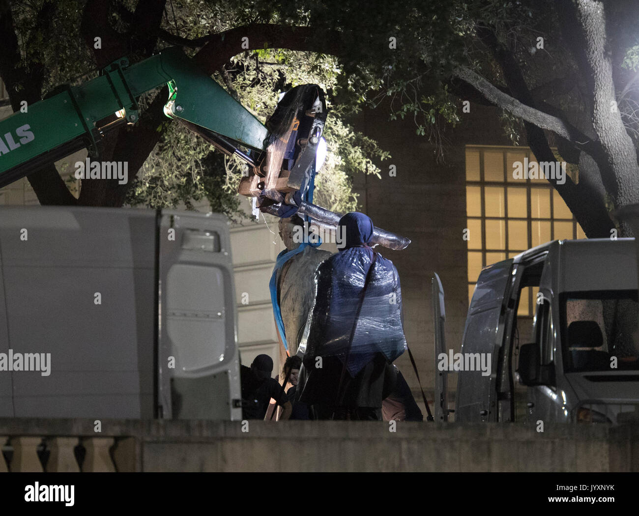 Workers remove the second of four statues of Confederate heroes at the University of Texas in a surprise midnight action before fall classes began in late August. The four are Stephen Hogg, Robert E. Lee, Sidney Johnston and John H. Reagan. Stock Photo
