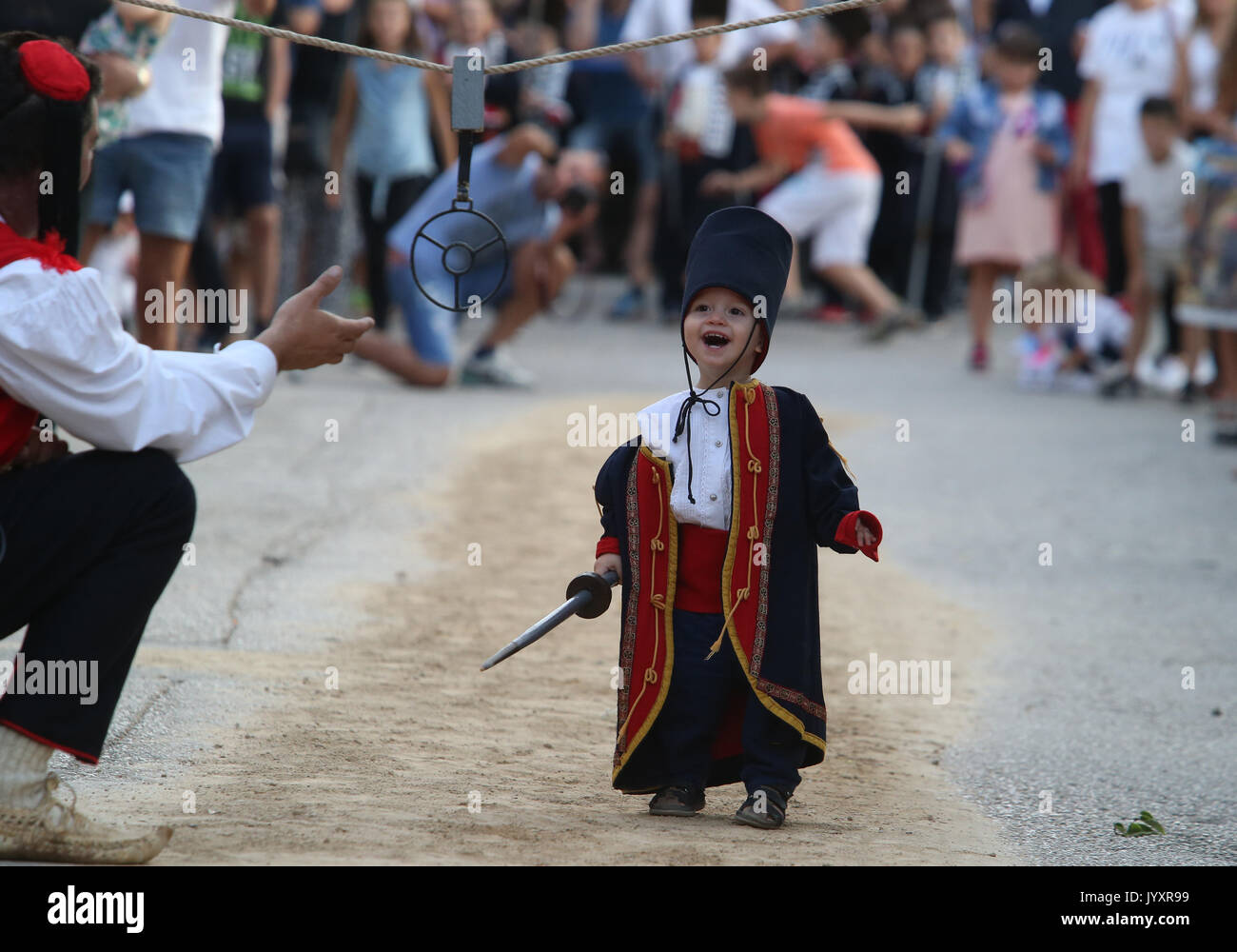 (170821) -- VUCKOVICI (CROATIA), Aug. 21, 2017 (Xinhua) -- A Boy participates in the Children's Alka lancing tournament in the village of Vuckovici, Croatia, on Aug. 20, 2017. Children's Alka is a lancing tournament held every August for boys up to ten years old since 1955 to commemorate their brave ancestors who defeated the Ottomans in 1715. (Xinhua/Ivo Cagalj) (zcc) Stock Photo