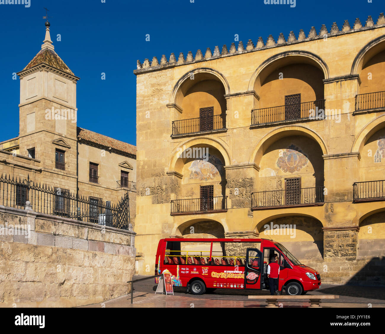 CORDOBA, SPAIN - MARCH 12, 2016: Red City Sightseeing bus in front of the Cathedral Stock Photo