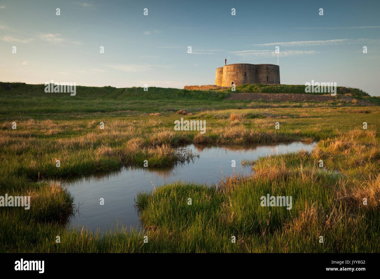 Martello tower on the east coast at Aldeburgh, Suffolk with Anthony Gormley sculpture. Stock Photo