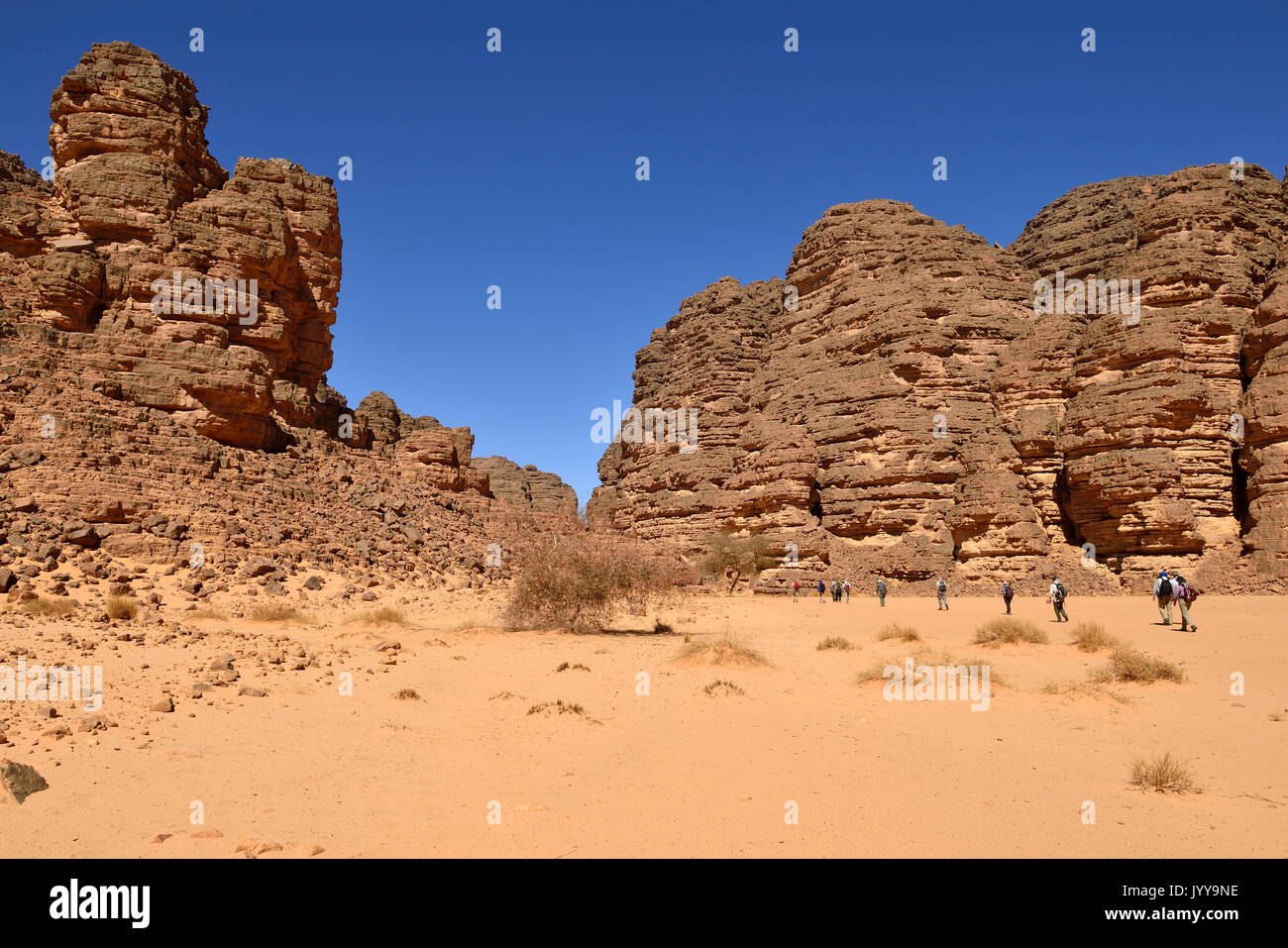 Hikers, group of people hiking in a canyon, Tassili n'Ajjer National Park, Sahara desert, Algeria Stock Photo