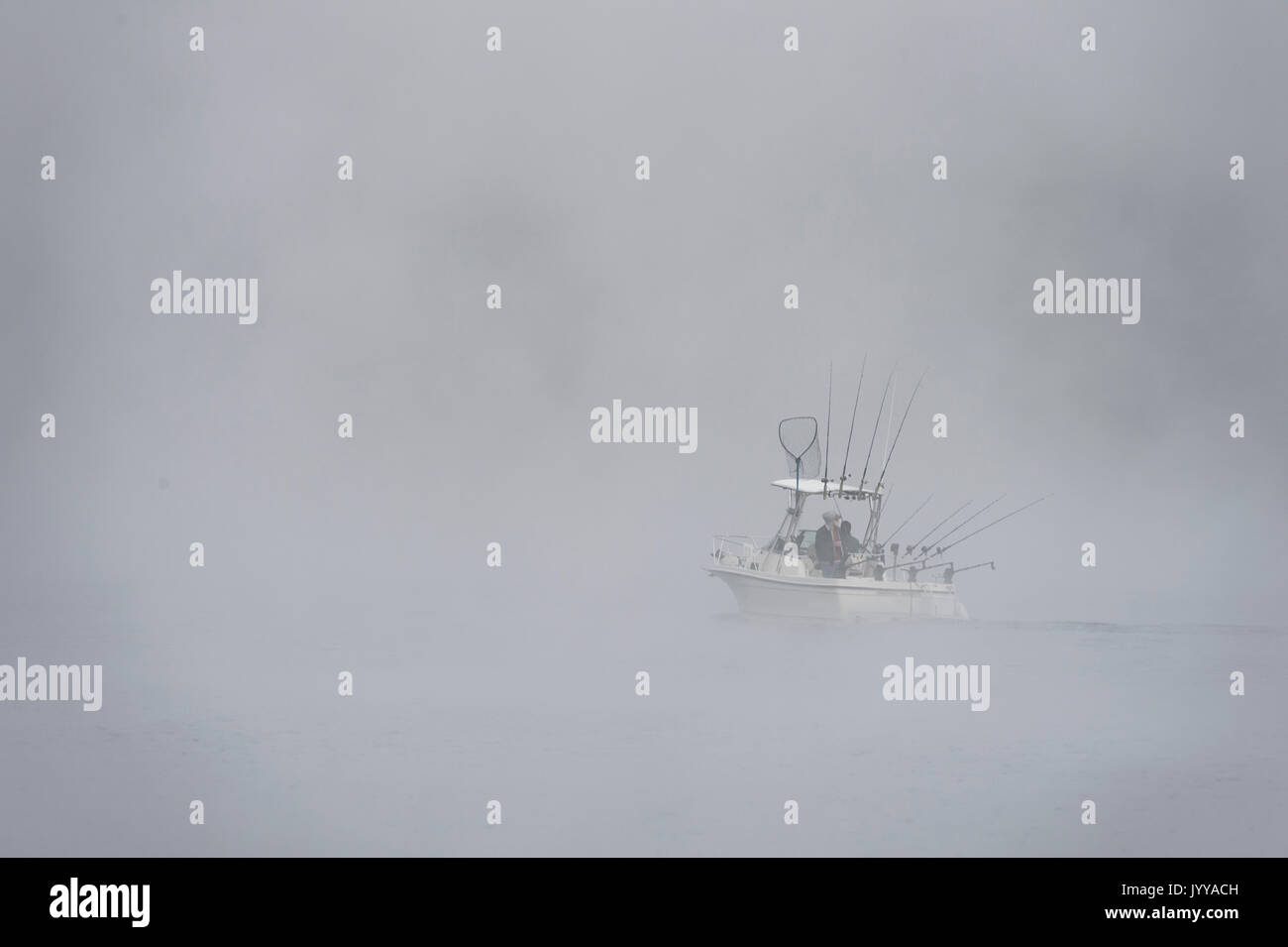 Fishing Boat On Lake In Thick Fog Stock Photo