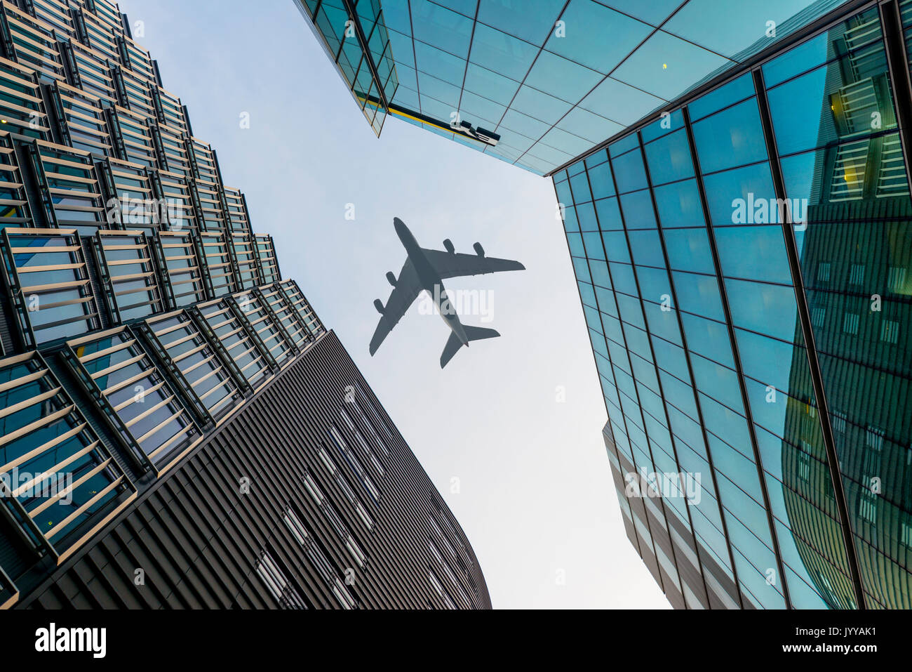 Airplane flying over skyscraper, low-angle view, London, England, United Kingdom Stock Photo
