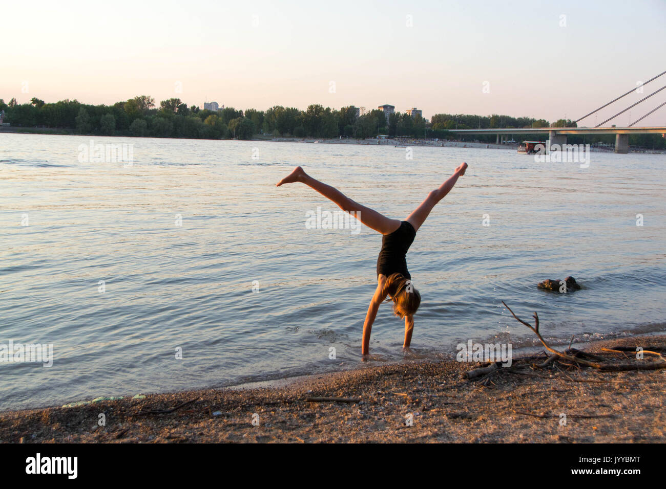 A little girl make hand stand, front walkover, back walkover, cartwheel, wolf jump, elbow stand Stock Photo