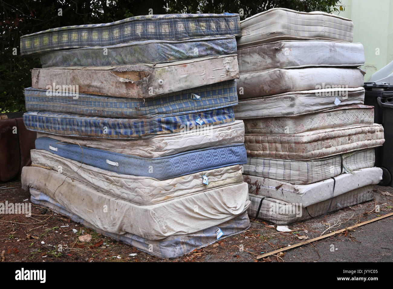 A stack of dirty mattresses are piled up on a roadside in Devon, UK
