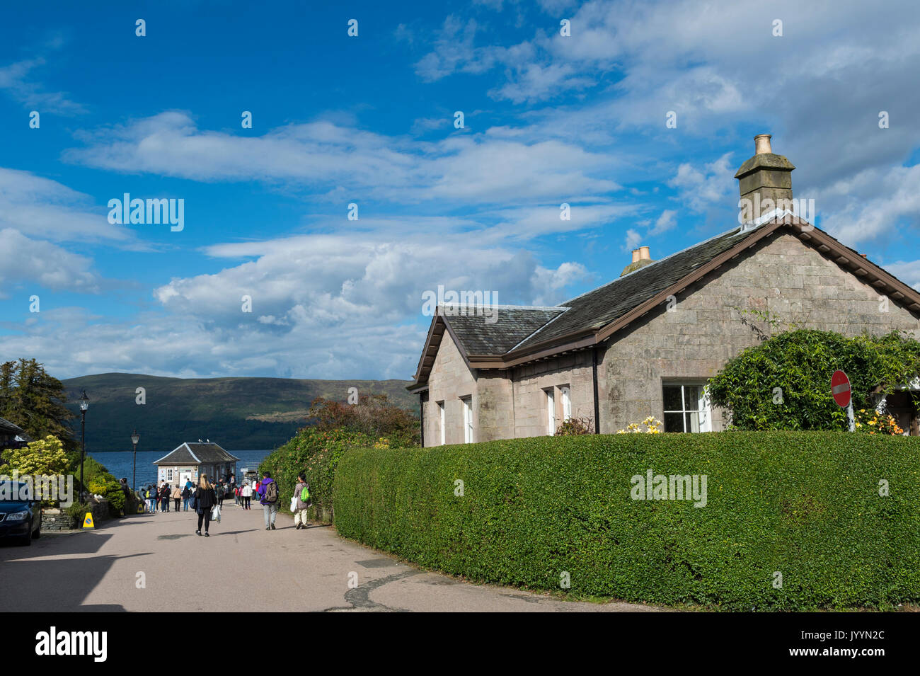 Luss, Scotland, UK - August 8, 2017: Tourists walking in the picturesque village of Luss on the banks of Loch Lomond. Stock Photo