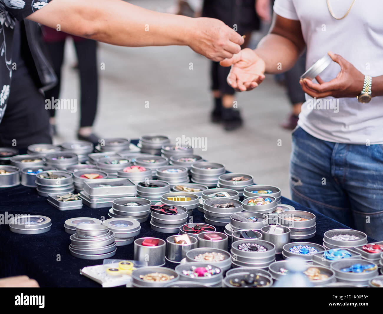 Fidget spinners An adult buying fancy metallic fidget spinner from a