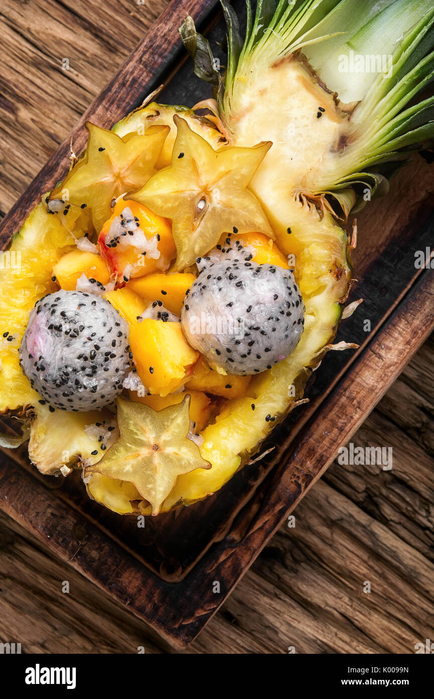 tropic fruits salad in pineapple cut in half Stock Photo