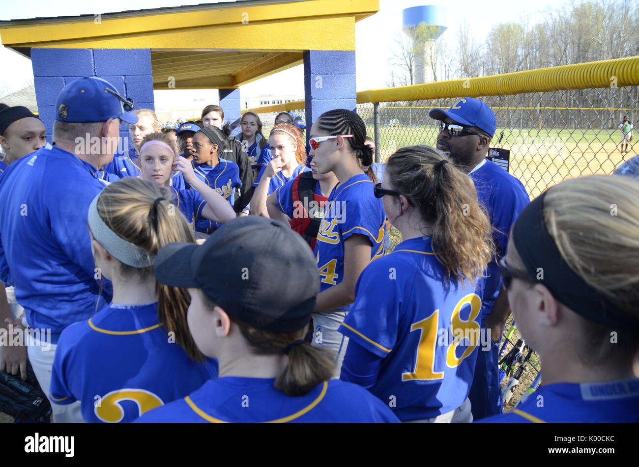 Softball coach discusses strategy with his team Stock Photo Alamy