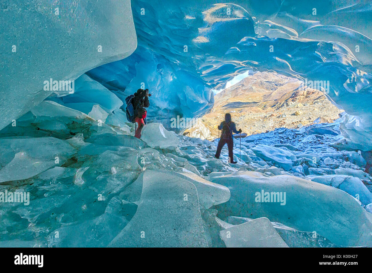 Hikers inside Forni Glacier Forni Valley Stelvio National Park Valfurva