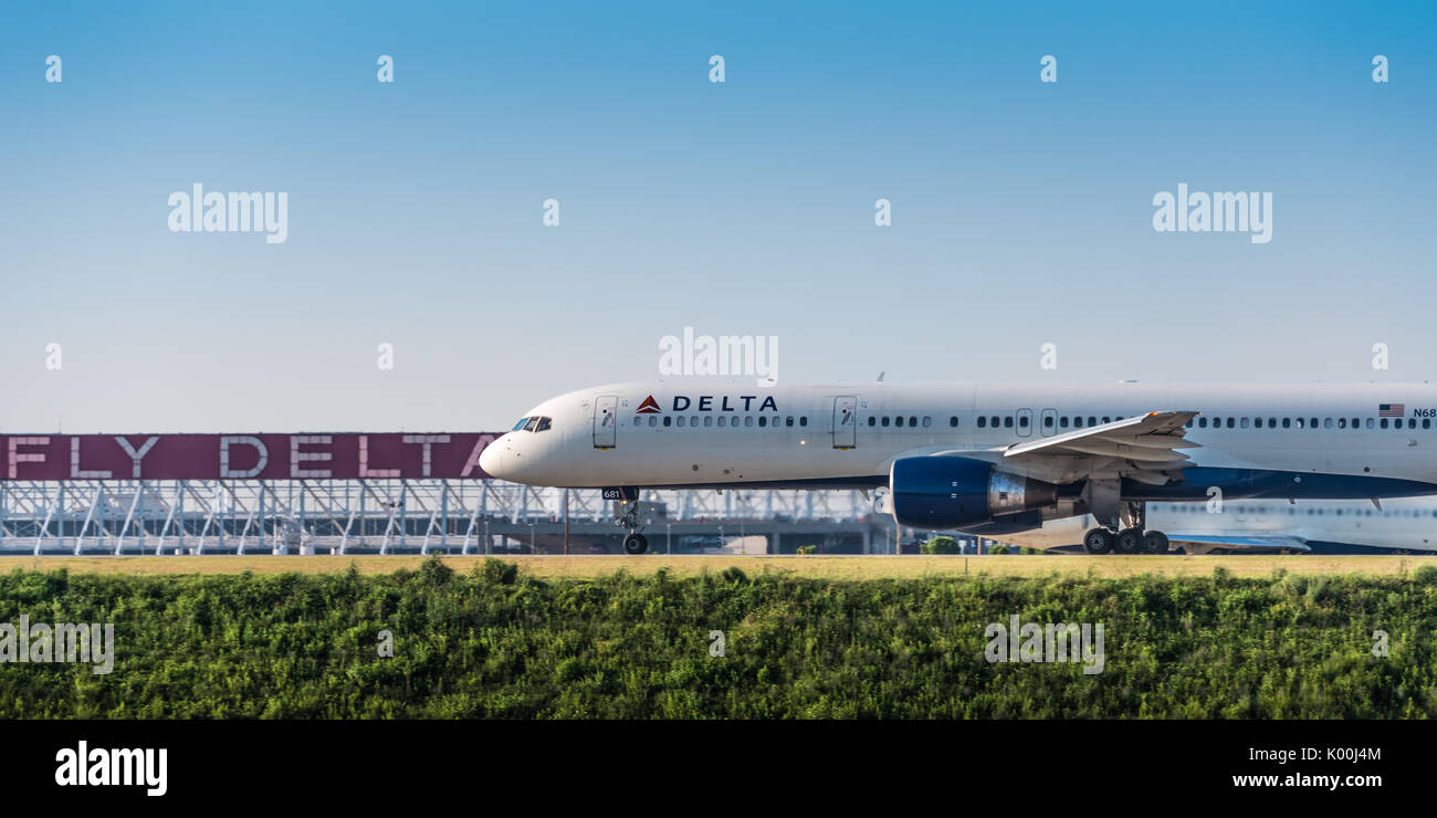 Boeing 757 Delta Air Lines passenger jet on the runway at Atlanta International Airport in front of the landmark Fly Delta Jets neon sign. (USA) Stock Photo