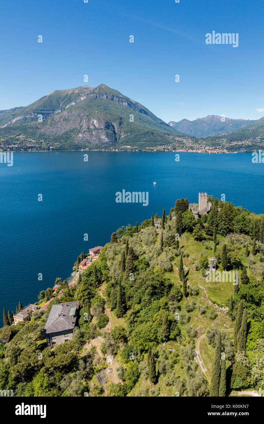 Aerial view of the green hill and castle overlooking Varenna surrounded by Lake Como Lecco Province Lombardy Italy Europe Stock Photo