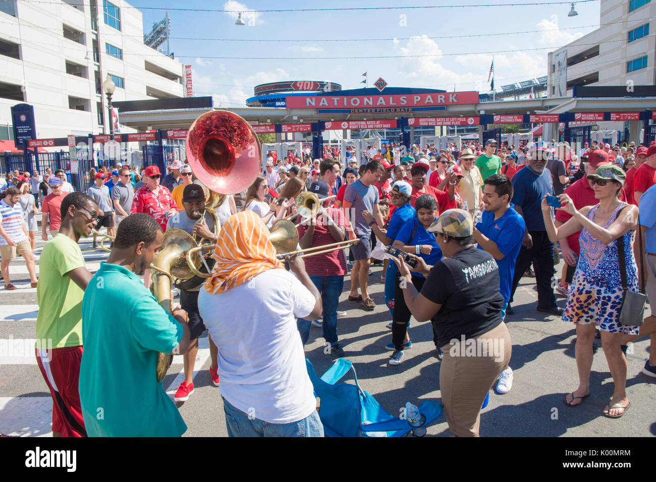 Street muscians play outside Nationals Park in Washington, DC, as baseball fans leave the stadium. Stock Photo
