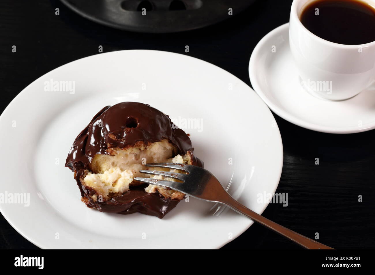 Choux with chocolate ganache and coffee cup Stock Photo