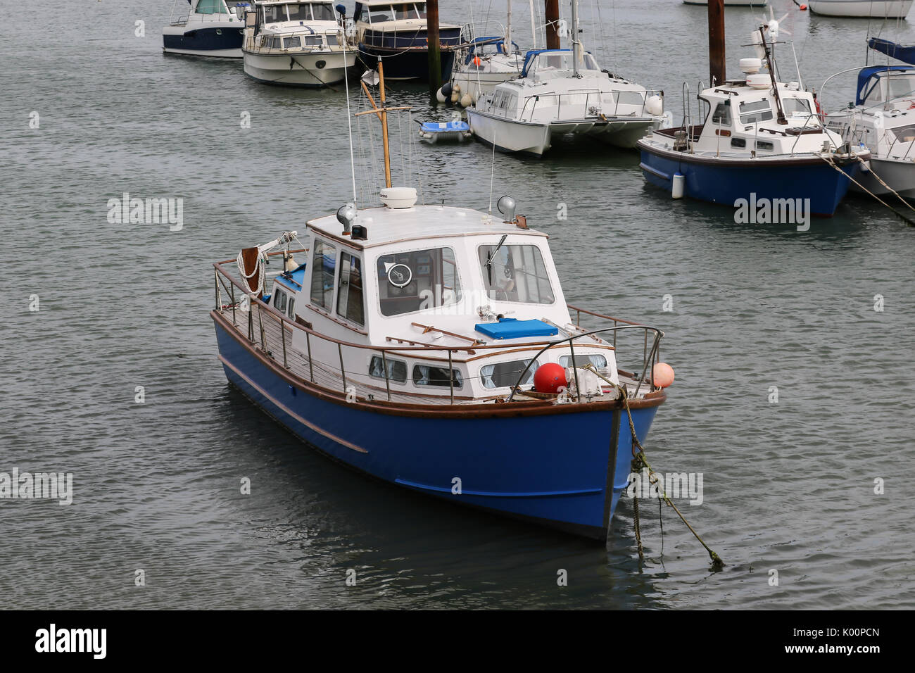 A small boat moored in Gosport Marina floats while the tide is out Stock Photo Alamy
