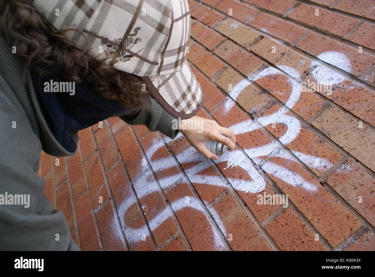 Vandalism, Teenager spray painting graffiti, criminal damage, Banksy Stock Photo Alamy