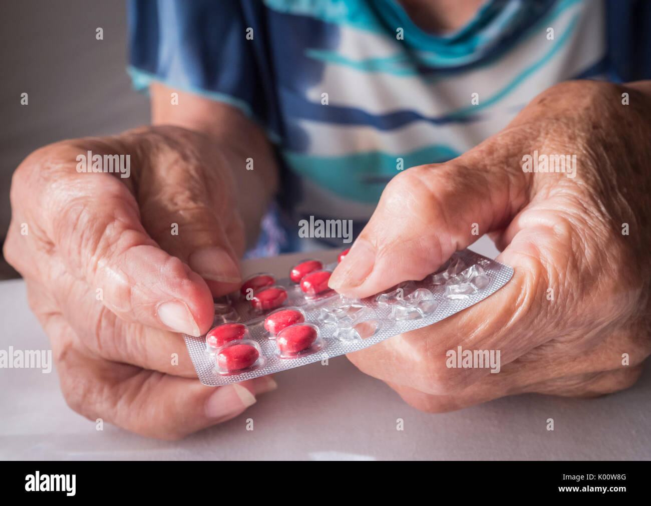 Oldster taking daily medication dose at home, Andalusia, Spain Stock