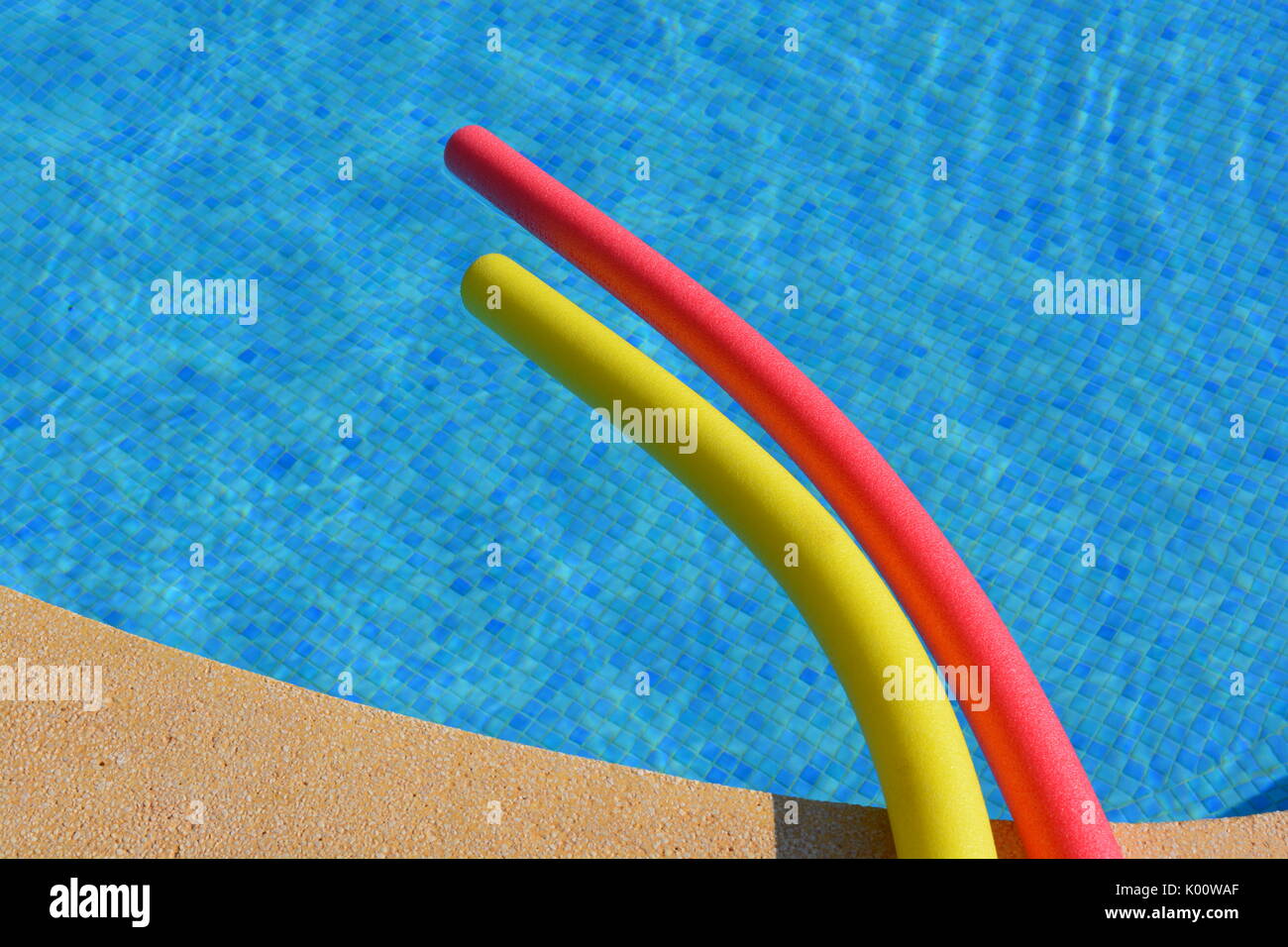 Pool noodles the edge of a swimming pool Stock Photo Alamy