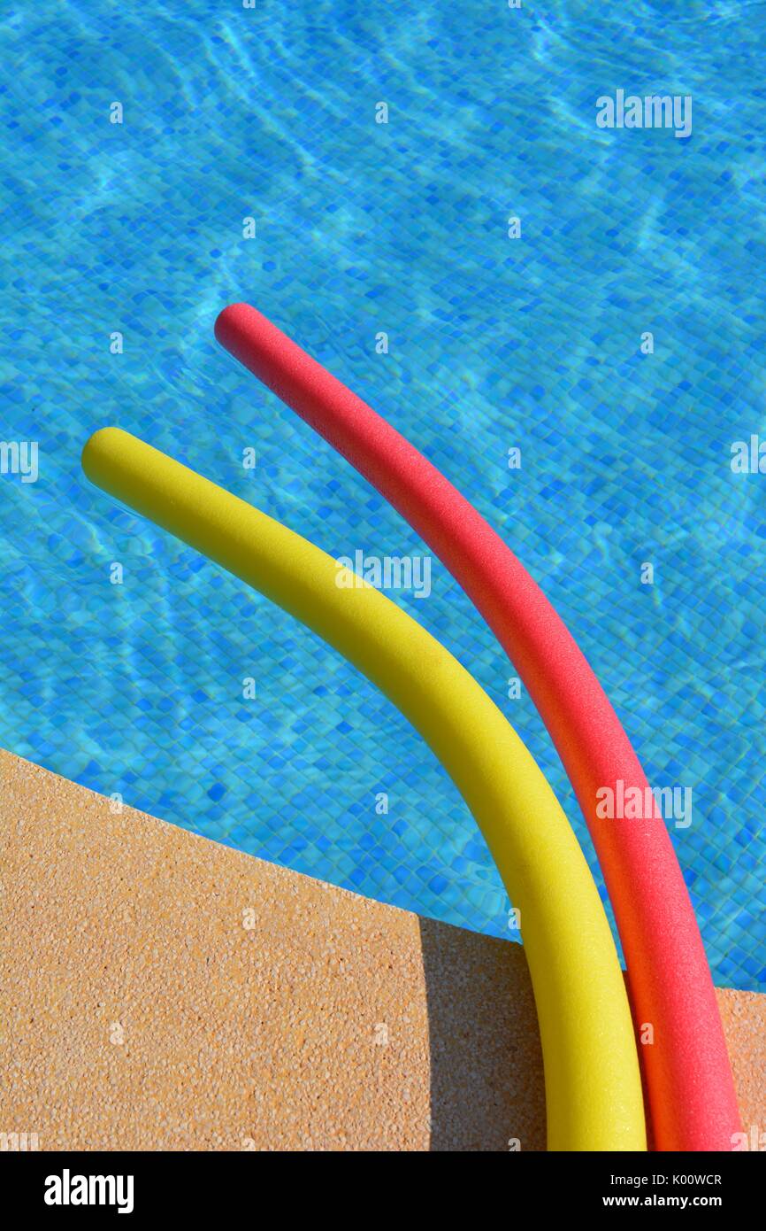 Pool noodles the edge of a swimming pool Stock Photo