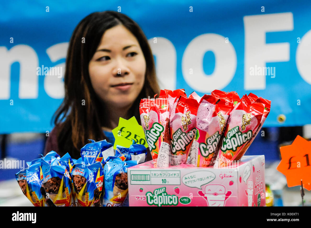Selection of Japanese snacks for sale with a Japanese woman behind