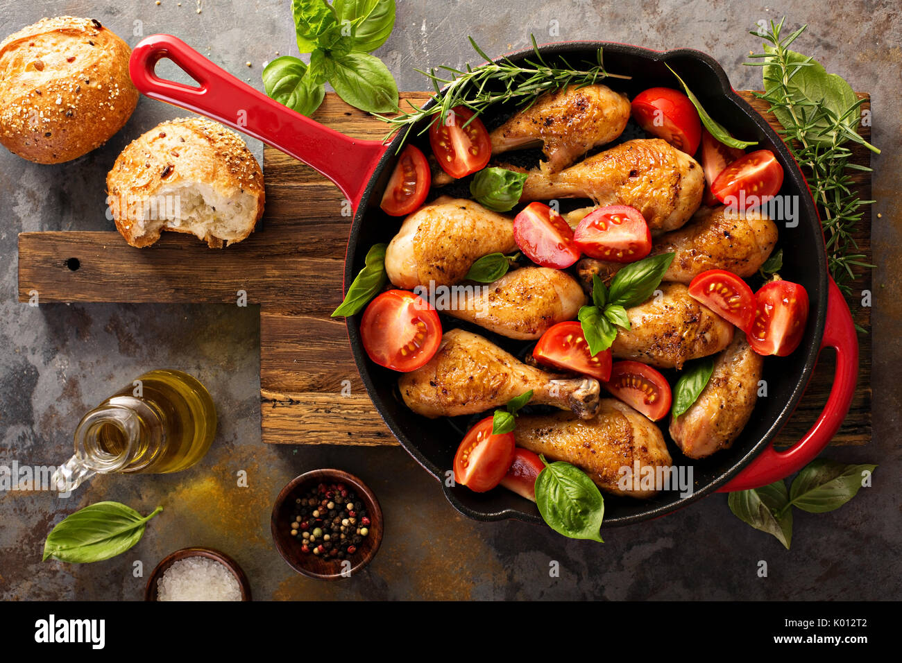 Roasted chicken drumsticks in a cast iron pan Stock Photo Alamy