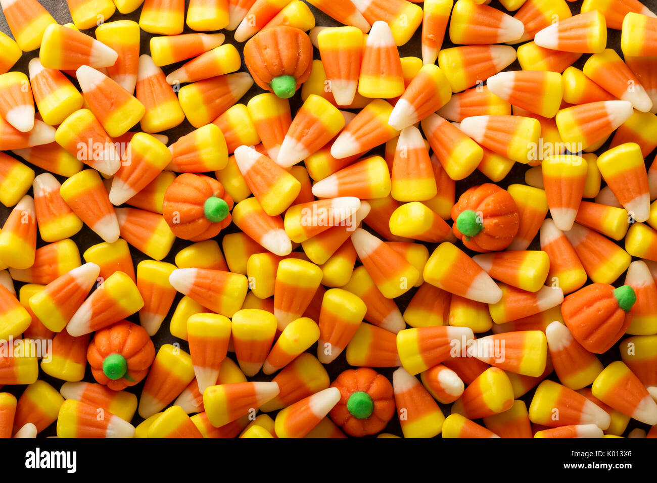 Candy corn and pumpkin Halloween background Stock Photo