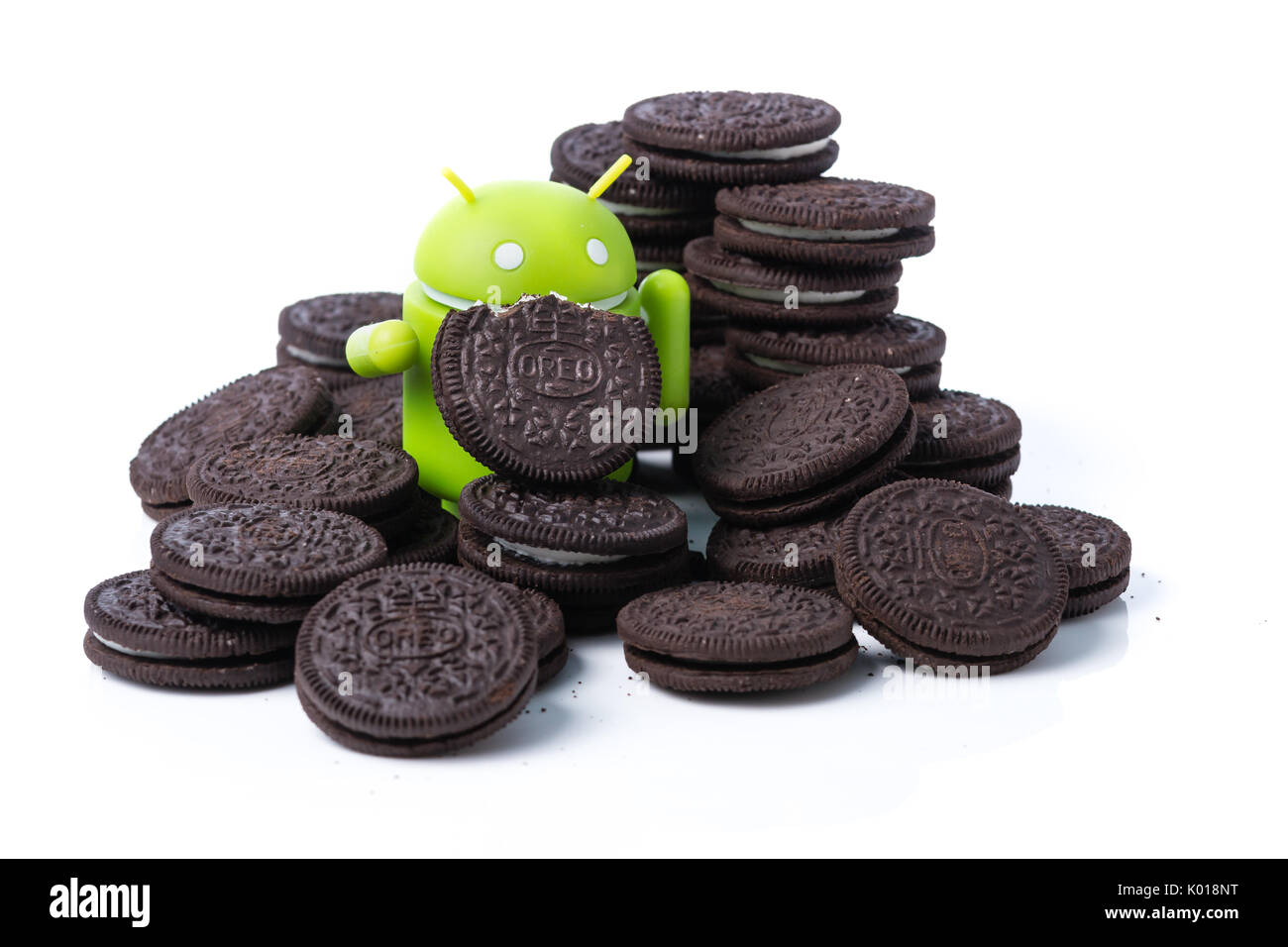 An android mascot surrounded by Oreo cookies Stock Photo