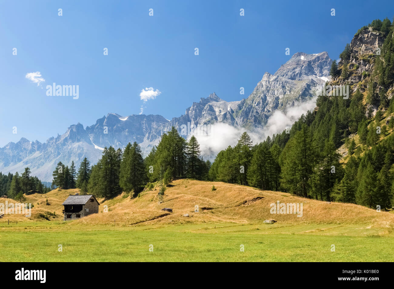 A small hut near Crampiolo and monte Cervandone in a summer day, Alpe Devero, Antigorio valley, Piedmont, Italy. Stock Photo