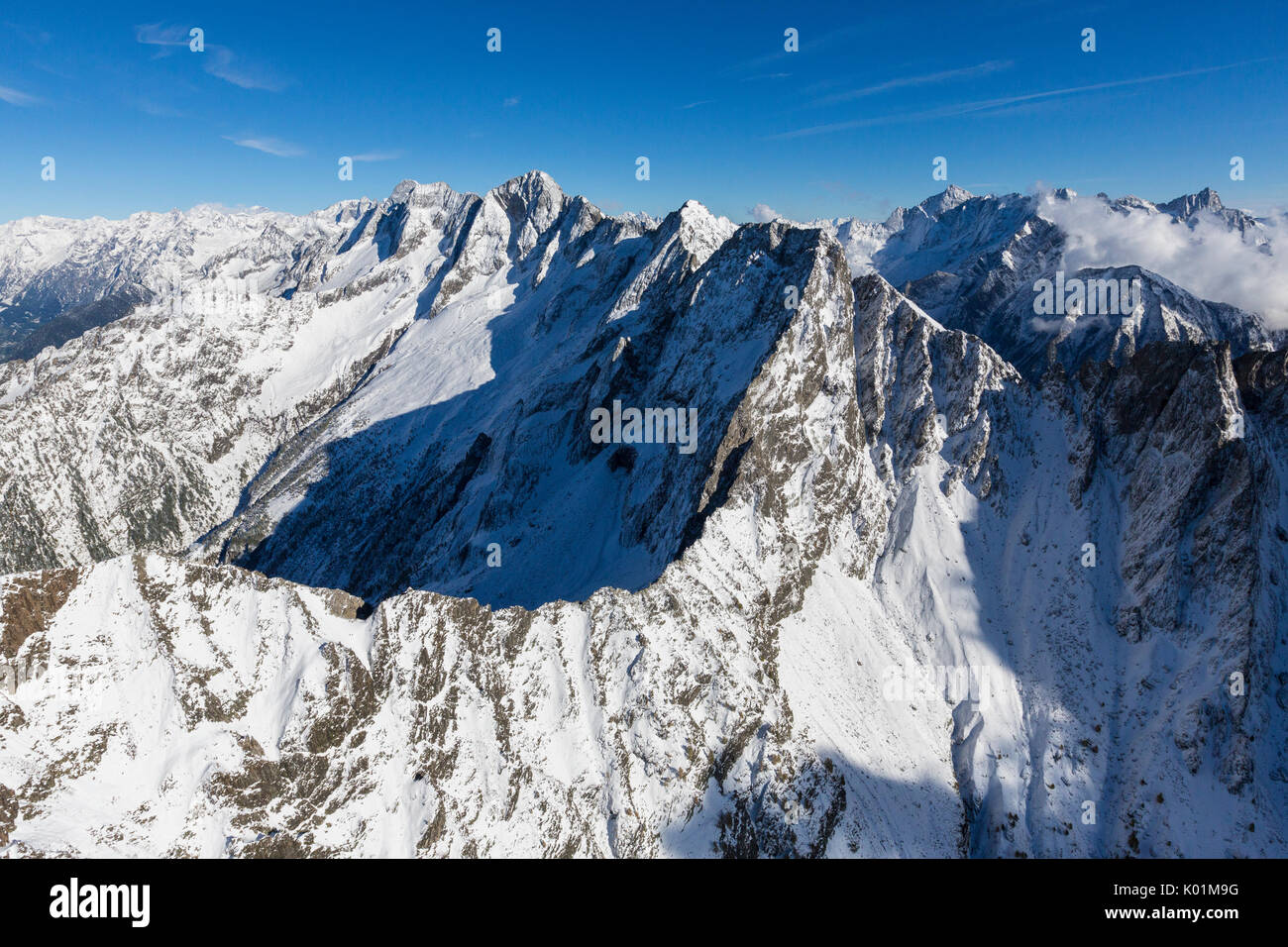 Aerial view of the snowy peaks and ridges in a sunny day of autumn Chiavenna Valley Valtellina Lombardy Italy Europe Stock Photo