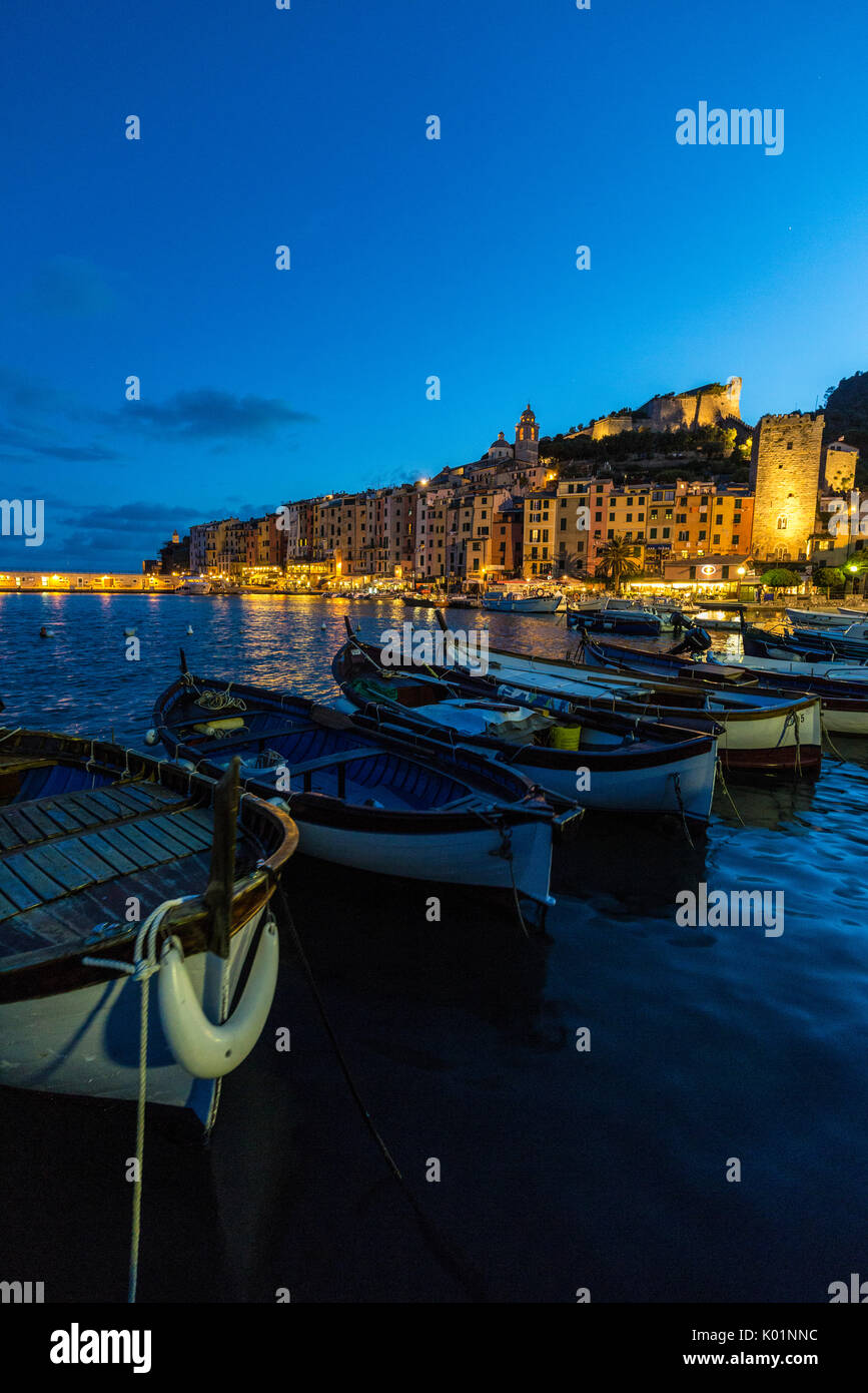 View of blue sea and boats surrounding the colorful village at dusk Portovenere province of La Spezia Liguria Italy Europe Stock Photo