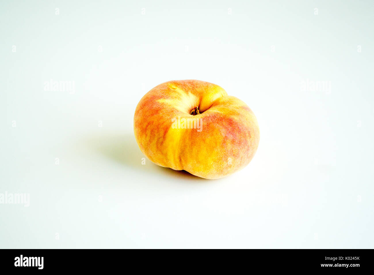 solitary donut peach isolated on white Stock Photo