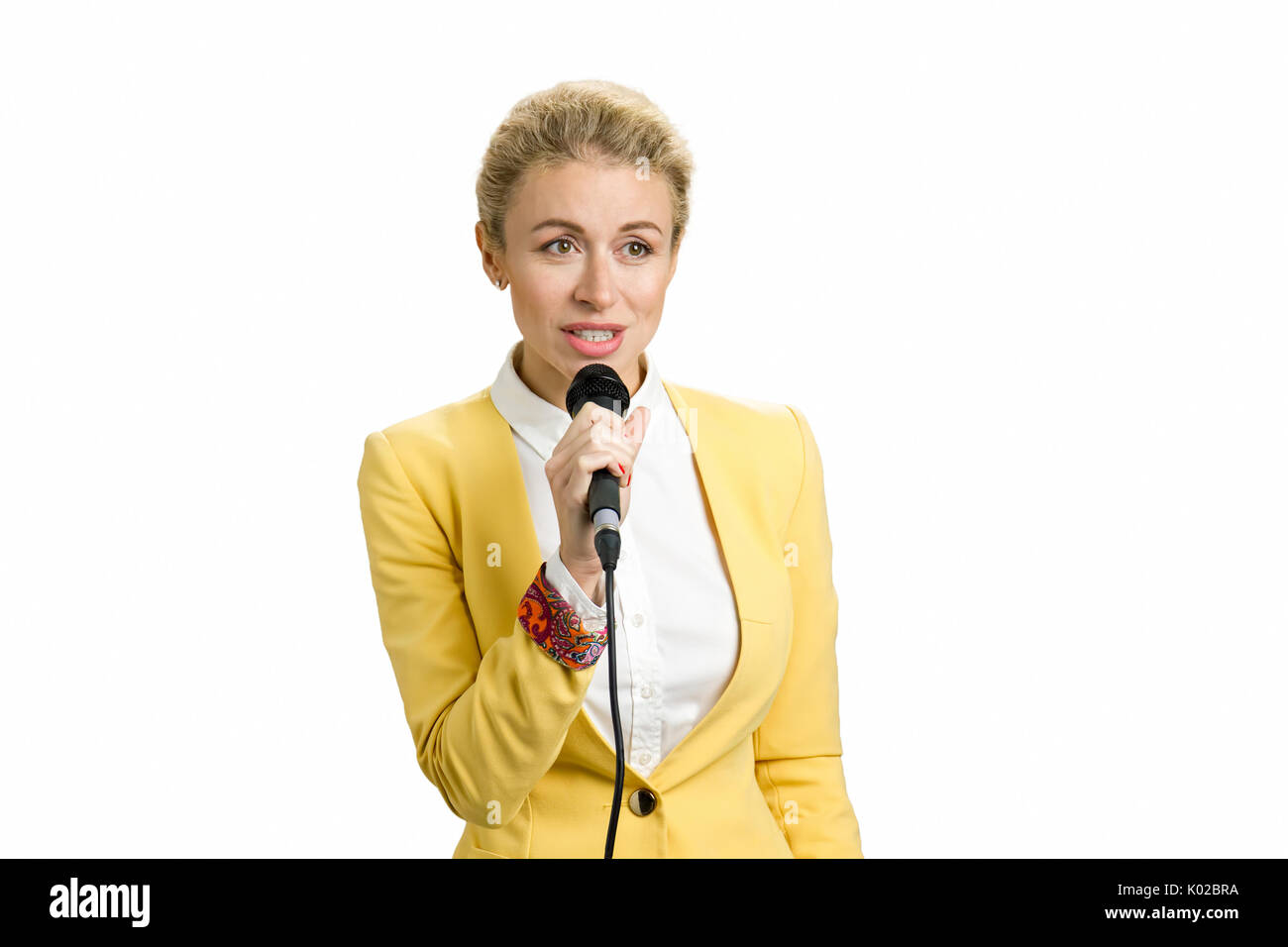 Young business woman speaking on microphone. Beautiful business woman