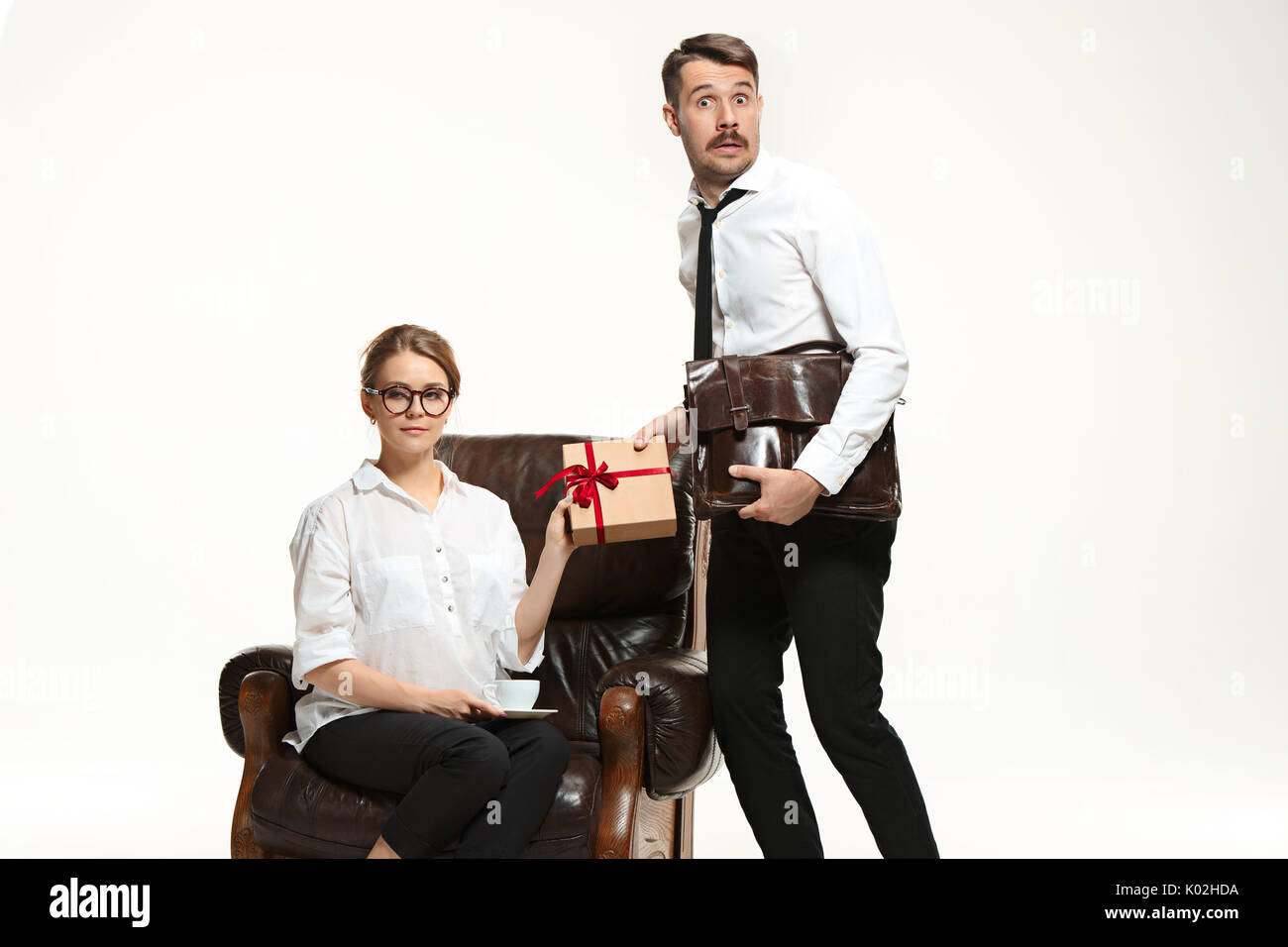 The young man and beautiful woman in business suit at office on white ...