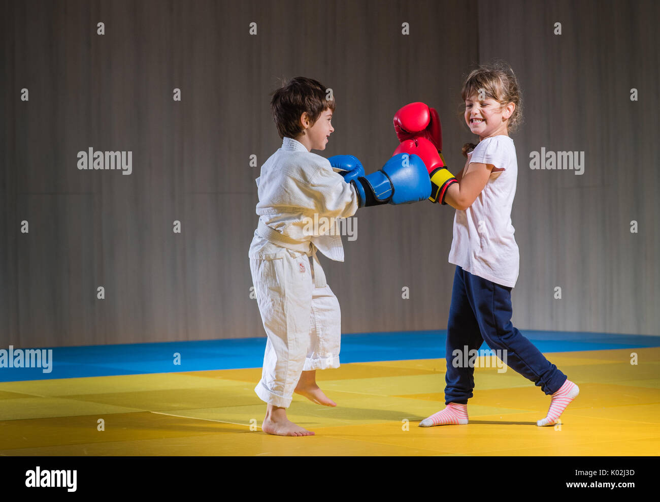 Young kids with boxing gloves training Stock Photo - Alamy