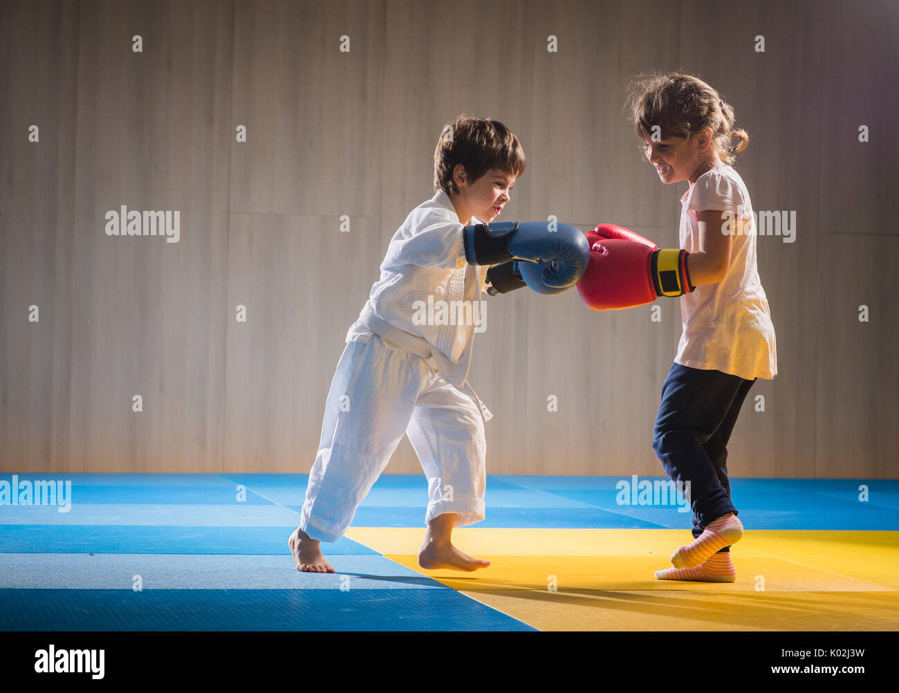 Young kids with boxing gloves training Stock Photo - Alamy