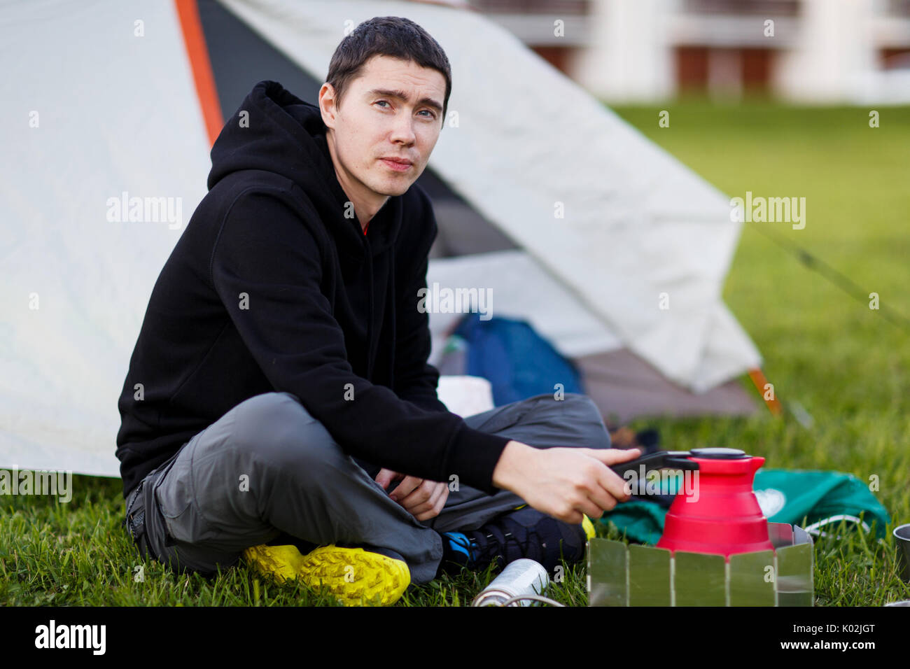 Young guy with tourist teapot Stock Photo