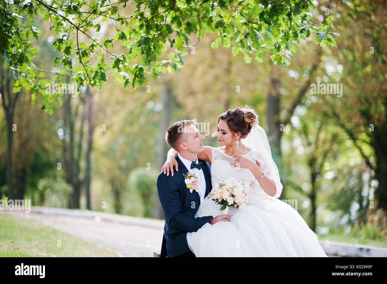 Bride sitting on lap groom hi-res stock photography and images - Alamy