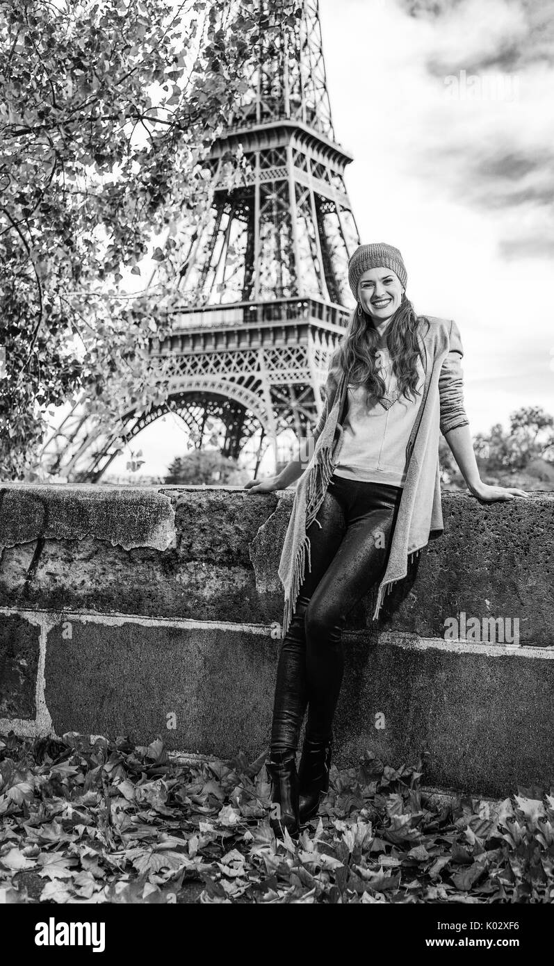 Autumn getaways in Paris. Full length portrait of happy young tourist woman on embankment near Eiffel tower in Paris, France Stock Photo