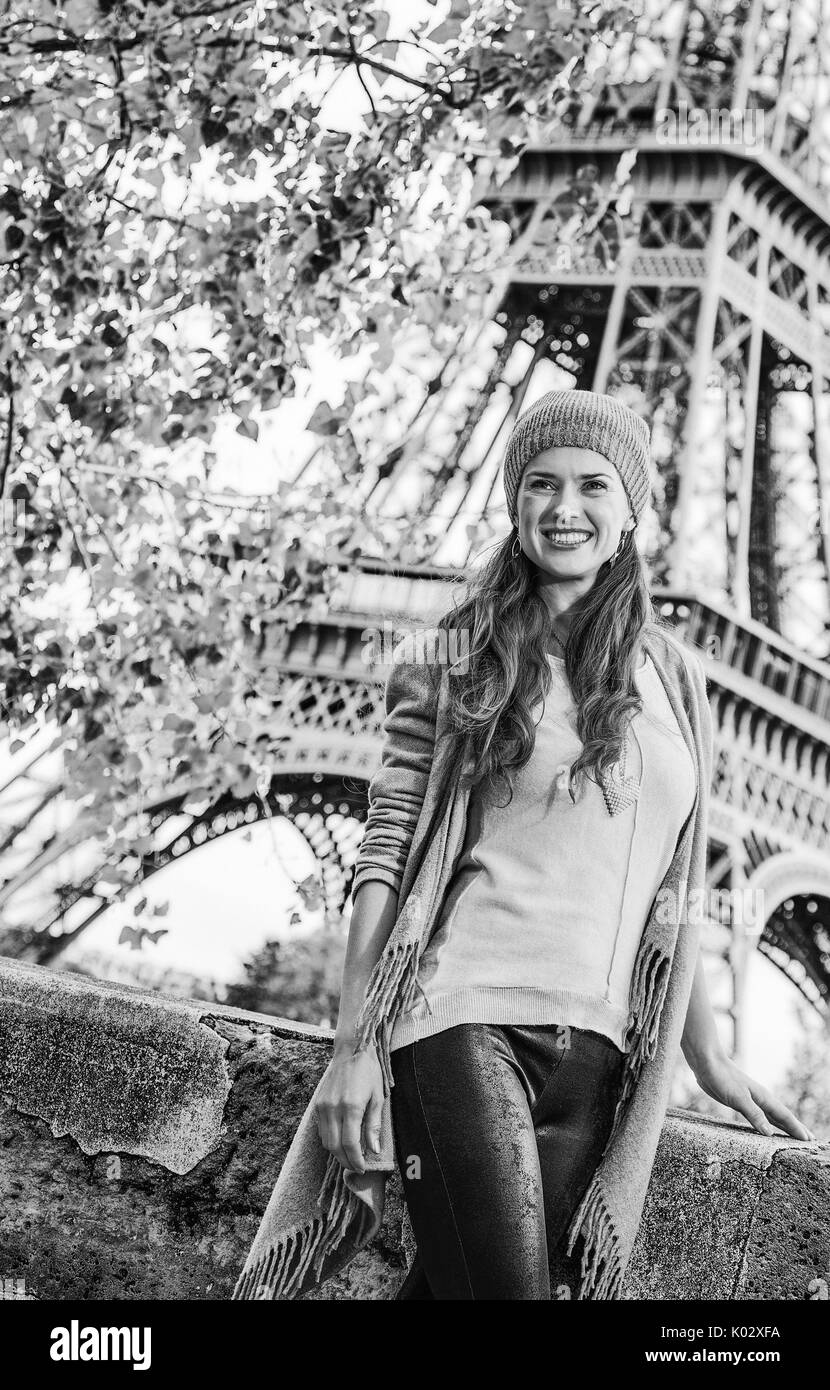 Autumn getaways in Paris. smiling young elegant woman on embankment near Eiffel tower in Paris, France exploring attractions Stock Photo