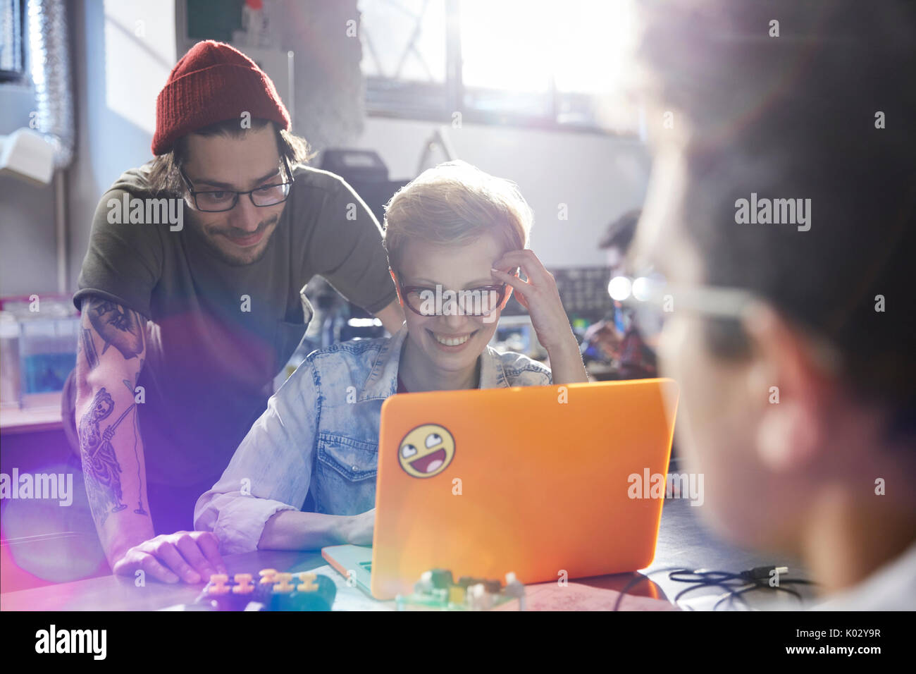 Designers working at laptop in workshop Stock Photo
