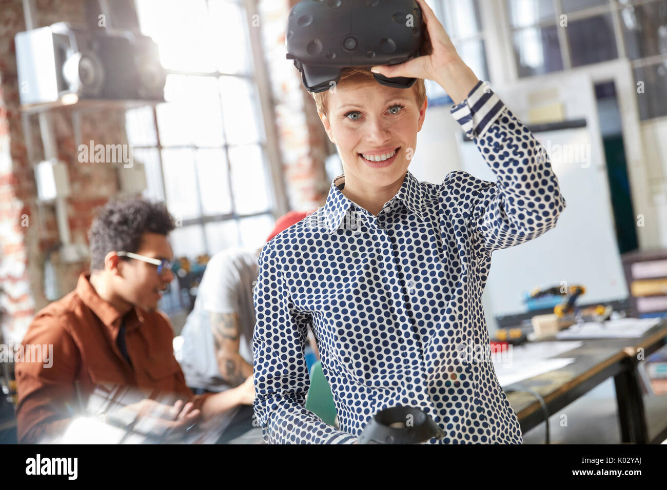 Portrait smiling female computer programmer wearing virtual reality simulator glasses Stock Photo