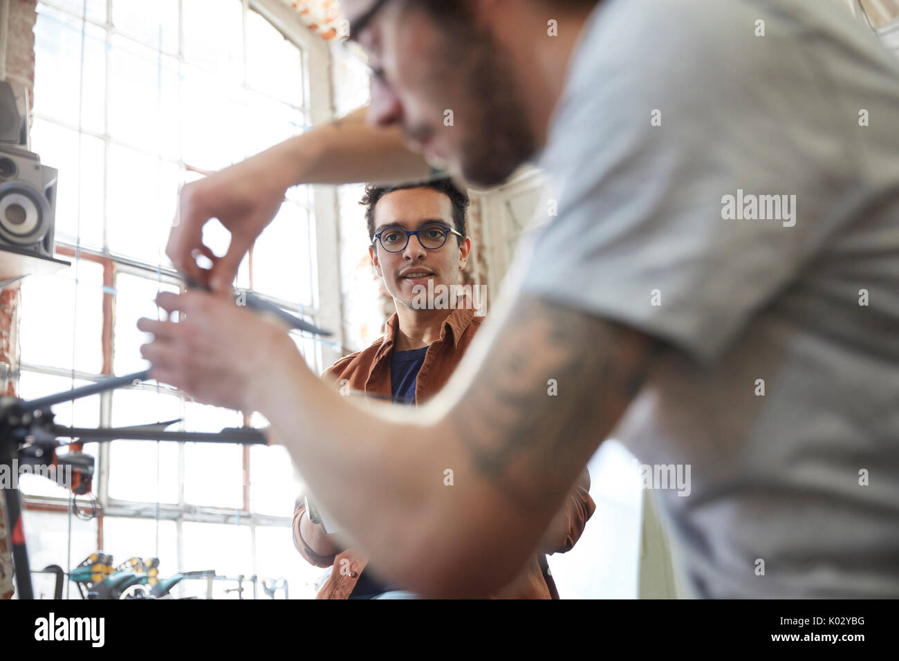 Male designers assembling drone in workshop Stock Photo