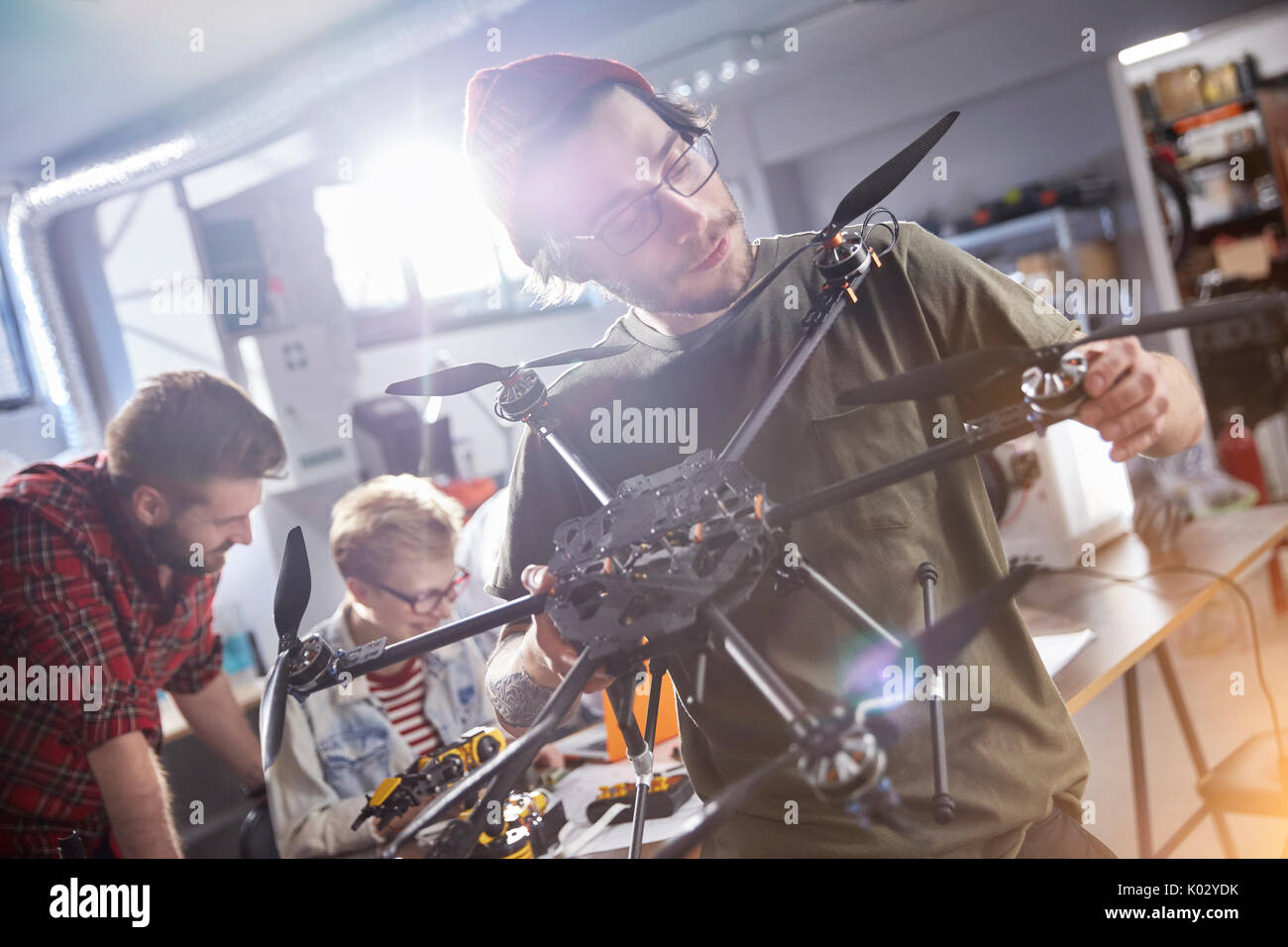 Male designer assembling drone in workshop Stock Photo