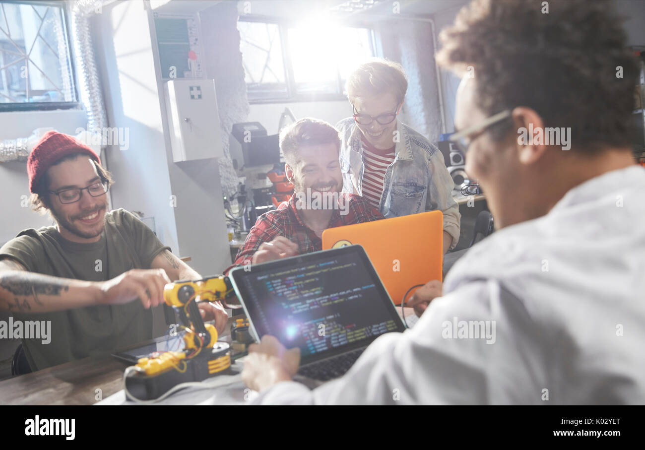Computer programmers programming robotics in workshop Stock Photo - Alamy