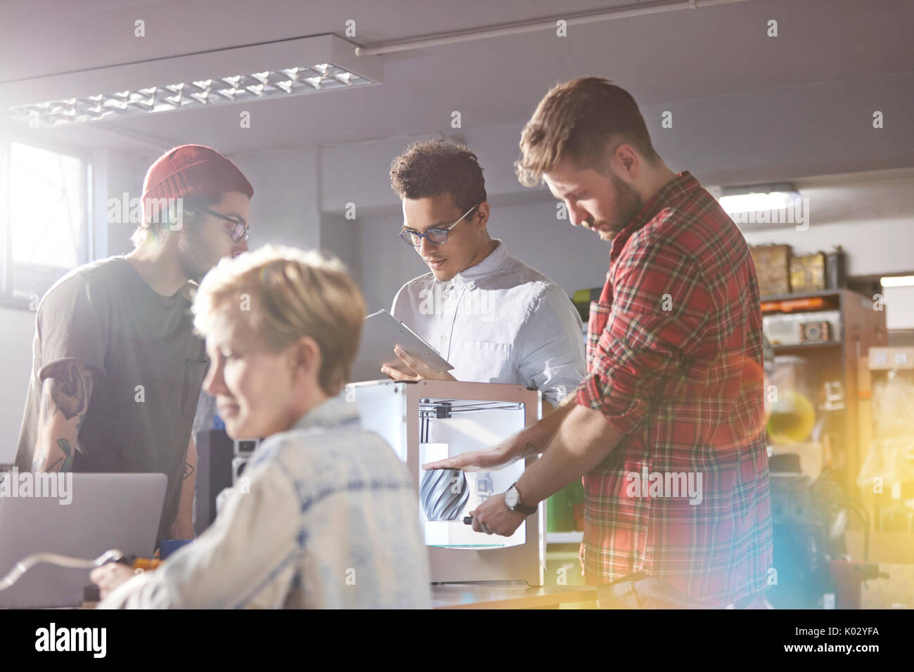 Designers using 3D printer in workshop Stock Photo