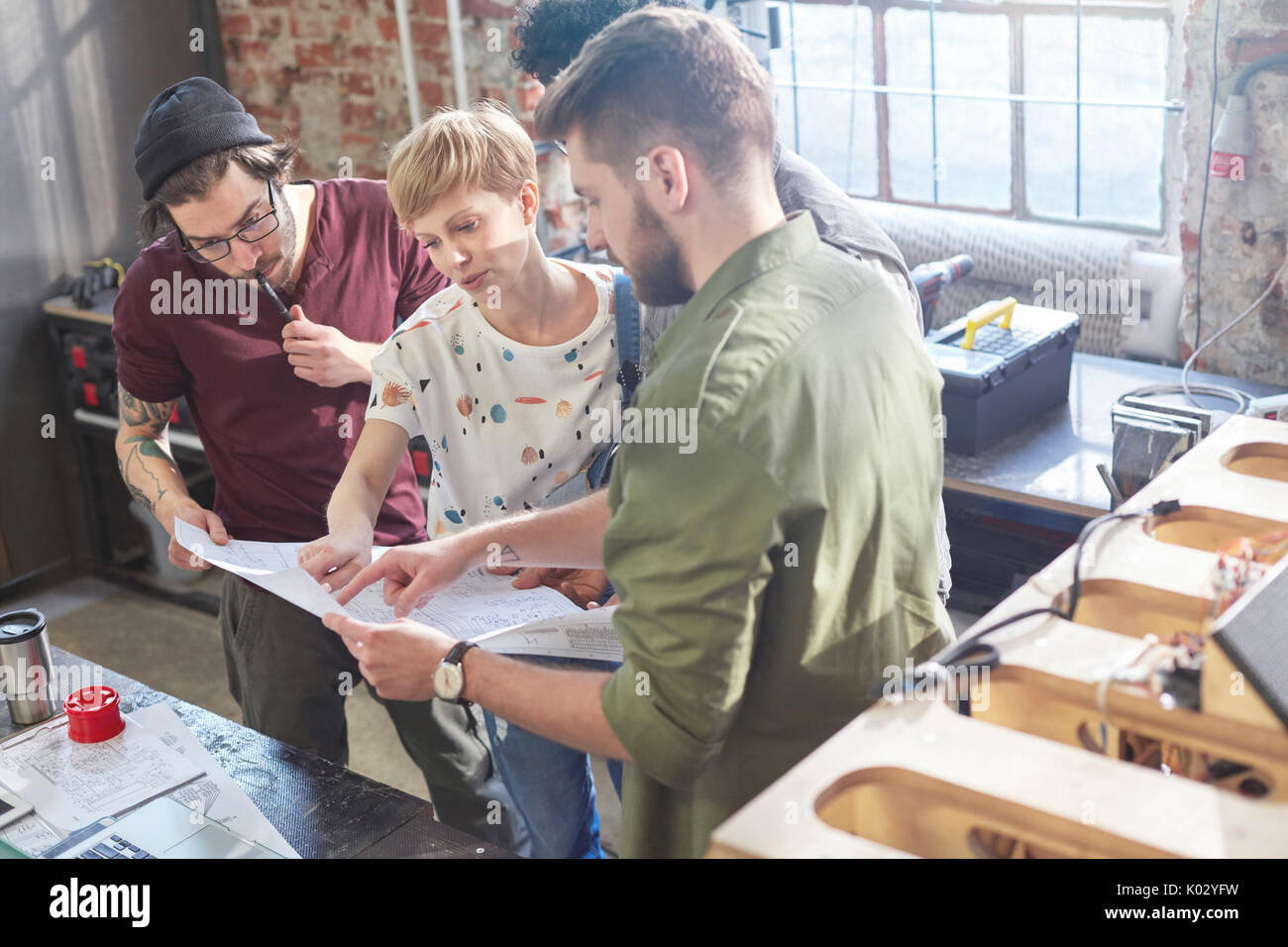 Designers meeting, reviewing plans in workshop Stock Photo