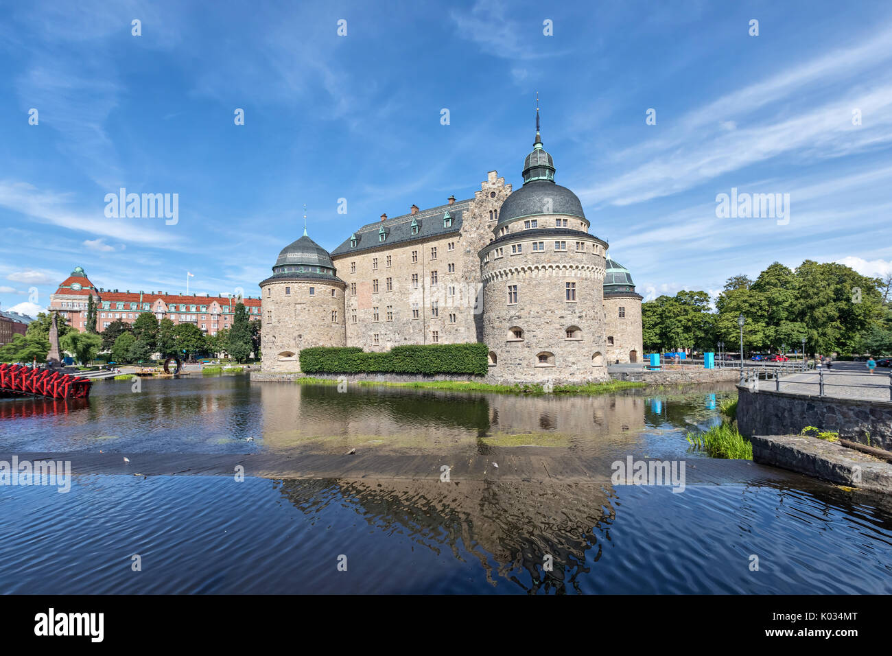 Orebro castle reflecting in water on sunny summer day in city Orebro, Sweden Stock Photo