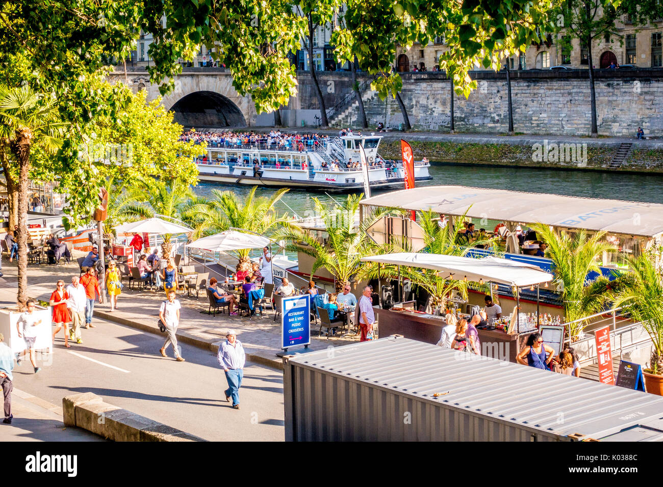 The Paris Plages is where locals and tourists go to enjoy summer by the Seine River, particularly late in the afternoon and evening. Stock Photo